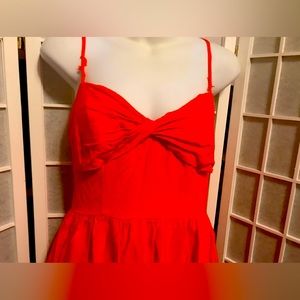 Monique Lhuillier features a twist-front bodice and a high-low A-line skirt.